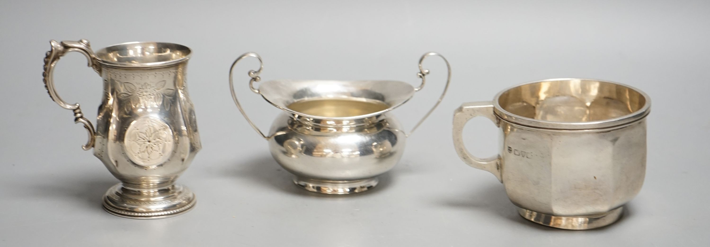 A Victorian silver christening mug, Birmingham, 1874, a later silver mug and a two handled sugar bowl